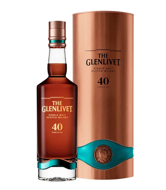 A bottle of The Glenlivet 40 Year Old Single Malt Scotch Whiskey 700mL stands next to its copper and teal cylindrical box, both prominently featuring The Glenlivet brand name and age statement.