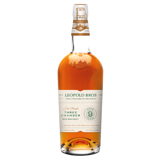 A bottle of Leopold Bros 9 Year Three Chamber Rye Whiskey Cask Strength Revival features a white and green label with gold accents, a circular “9” emblem, and amber liquid, celebrating this 9-year aged rye whiskey.