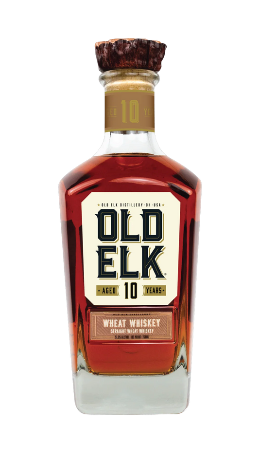 A bottle of Old Elk Bourbon’s 10 Year Straight Wheat Whiskey, adorned with a wooden cap and a cream label accented by bold dark lettering and gold highlights—this premium American whiskey exemplifies refined craftsmanship and character.