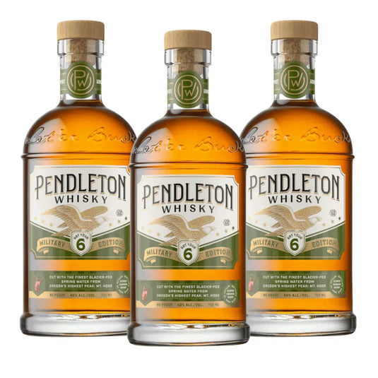 Three bottles of Pendleton Whisky Military Edition 2026, each featuring a green and gold military-themed label with an eagle emblem, a wooden cap, and the number 6 prominently displayed on the front. This limited edition Canadian whisky from Pendleton Whisky honors service and tradition.
