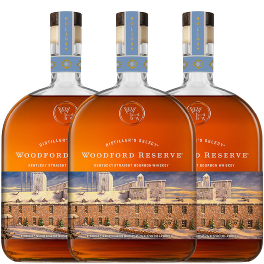 Three bottles of Woodford Reserve are lined up, featuring the Woodford Reserve Bourbon Holiday Edition 2026 750ml with festive labels and a distillery illustration.