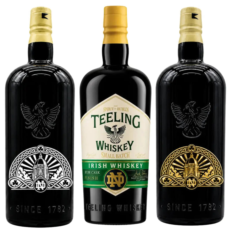 Load image into Gallery viewer, Three bottles from the Teeling x Notre Dame 2026 Custom Deep Etched Irish Whiskey Heritage Bundle by Teeling Whiskey are displayed; the center bottle showcases a detailed label, while the two side bottles feature deep etched Notre Dame Heritage logos in gold and silver with an eagle emblem.
