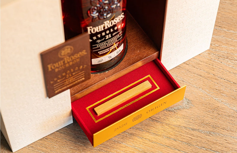Load image into Gallery viewer, Four Roses The Anthology Series Chapter 1: Origin 21 Year Bourbon from Main Street Liquor is presented in an elegant box with a red velvet compartment and gold plaque, set on a wooden surface—an impressive collectible bourbon display.
