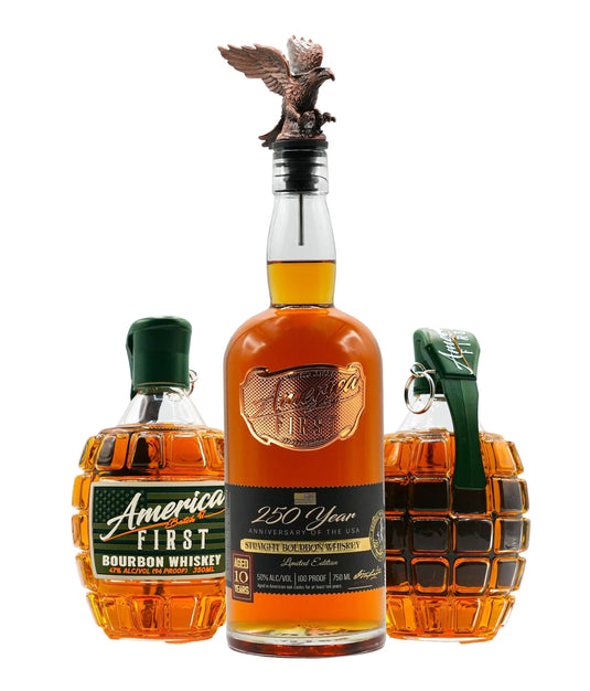 Three whiskey bottles: two America First Grenade Whiskey Bottles, labeled “America First Bourbon Whiskey,” flank a central America First 250th Anniversary Bourbon bottle with an eagle stopper. All bottles, part of the America First Limited Edition Bourbon Bundle, contain amber liquid.