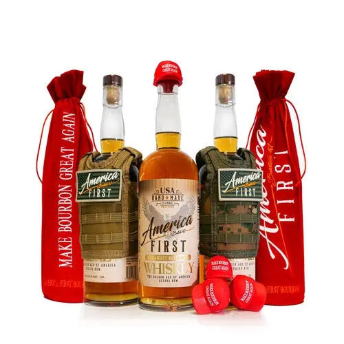 Three bottles of America First Straight Bourbon Whiskey Collectors Edition 3-Pack—two presented in camouflage holders—are flanked by vibrant red bags featuring the slogans MAKE BOURBON GREAT AGAIN and America First. This collectible bourbon set is finished with three bold red caps showcased prominently at the front.