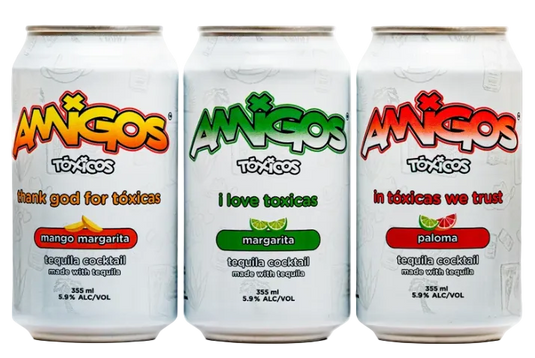 Six white cans of Amigos Toxicos Tequila Cocktail Variety Pack 6-Pack, each featuring a different flavor: mango margarita, lime margarita, and paloma. Every can showcases a vibrant phrase and unique design that reflects its flavor, making this ready-to-drink tequila cocktail pack from Amigos Toxicos perfect for any occasion.