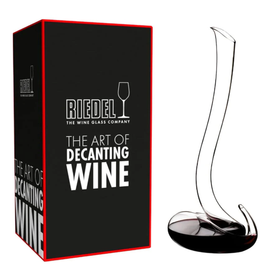A Riedel Wine Decanter Eve with a tall, elegantly curved neck sits beside its black and red box labeled "Riedel: The Art of Decanting Wine," exemplifying the exceptional wine aeration achieved by this exquisite crystal decanter from Riedel.