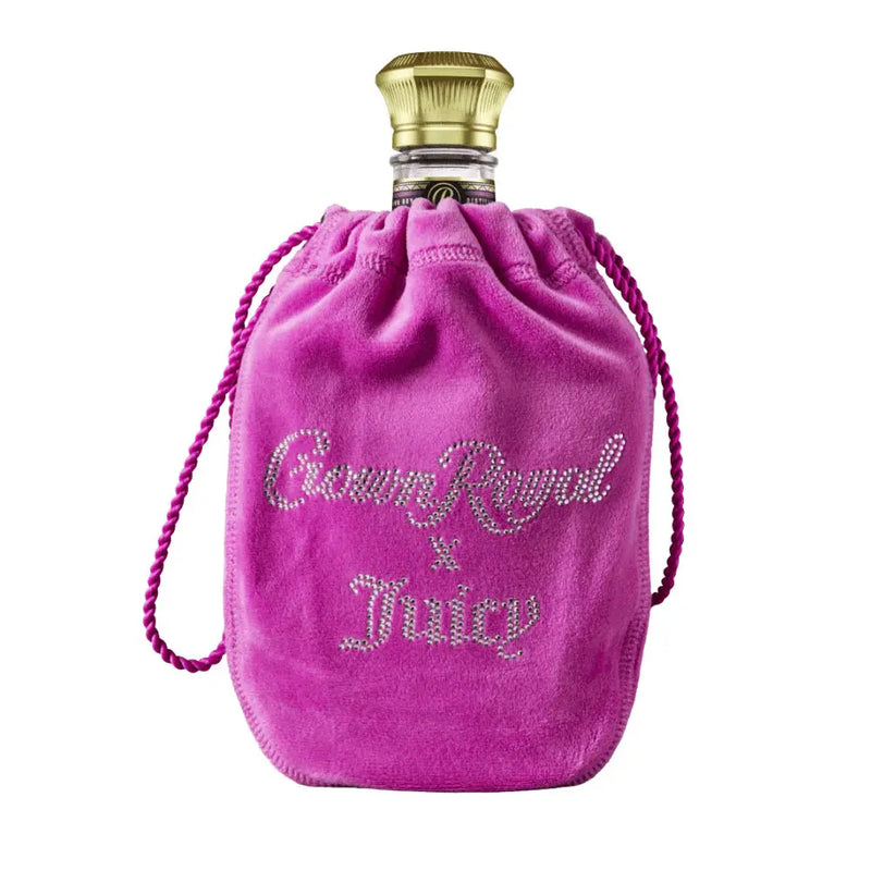 Load image into Gallery viewer, A Crown Royal Blackberry x Juicy Couture Limited Edition bottle in a bright pink velvet bag with “Crown Royal x Juicy” in rhinestone-style letters, marking the exclusive Crown Royal and Juicy Couture collaboration.
