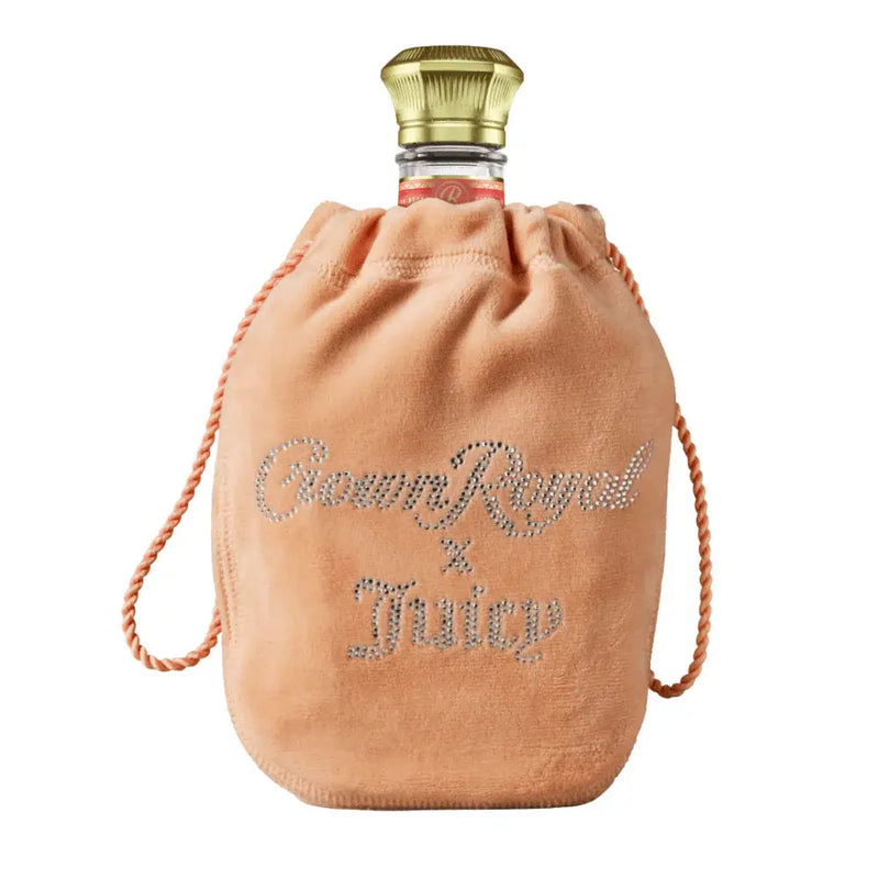 Load image into Gallery viewer, The Crown Royal Peach X Juicy Couture limited edition features a gold-capped bottle in a peach velvet pouch with “Crown Royal x Juicy” in rhinestones—a special release from Crown Royal.
