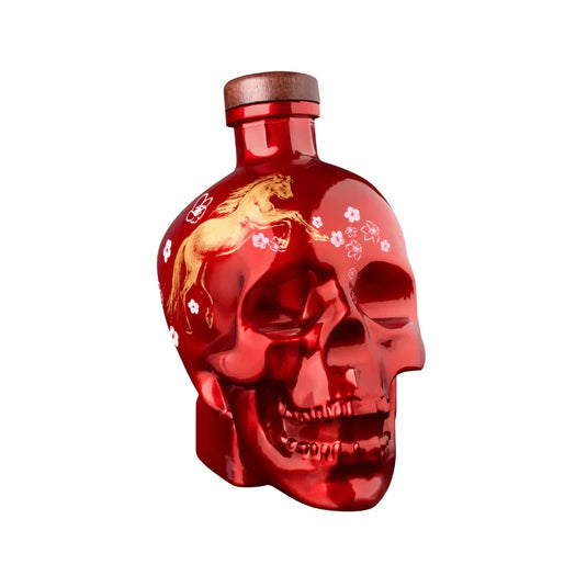 The Crystal Head Vodka Year of the Horse 2026 Lunar New Year Limited Edition features a shiny red skull-shaped bottle with a golden unicorn and white flowers, a wooden cap, all set against a plain white background.