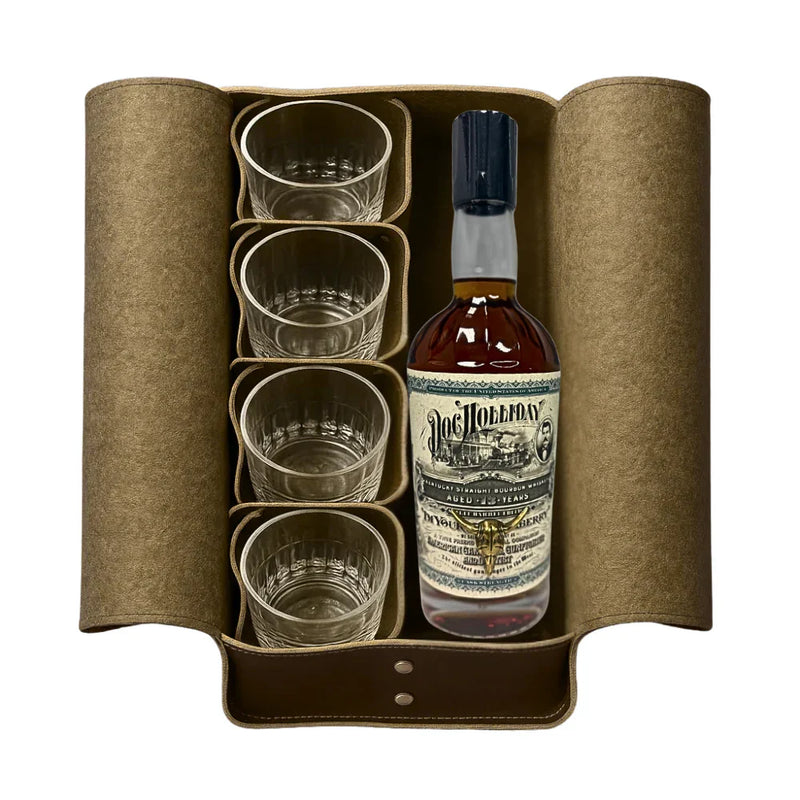 Load image into Gallery viewer, A brown leather case holds a bottle of Doc Holliday 13 Year Doctor's Bag Single Barrel Bourbon (Pre-Order) by Doc Holliday and four clear glass tumblers, all neatly arranged side by side.
