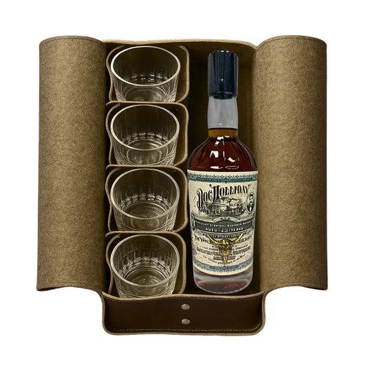A brown leather case holds a bottle of Doc Holliday 13 Year Doctor's Bag Single Barrel Bourbon (Pre-Order) by Doc Holliday and four clear glass tumblers, all neatly arranged side by side.