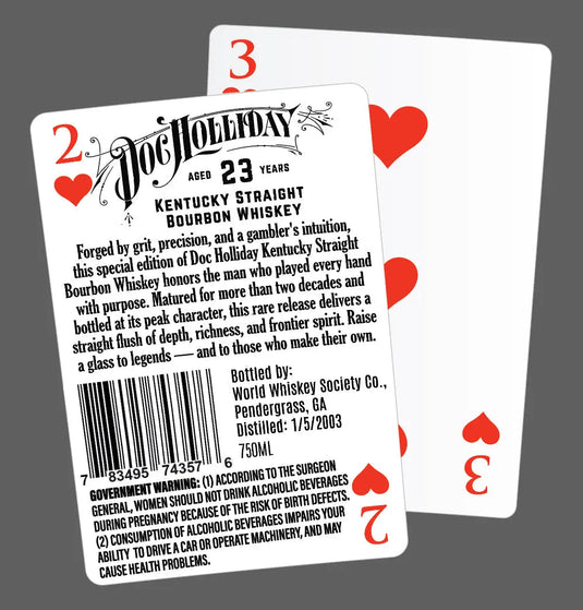Two playing cards overlap on a gray background. The front card, the 2 of Hearts, displays a label for Doc Holliday 23 Year Kentucky Straight Bourbon Whiskey. The 4 of Hearts card is behind it.