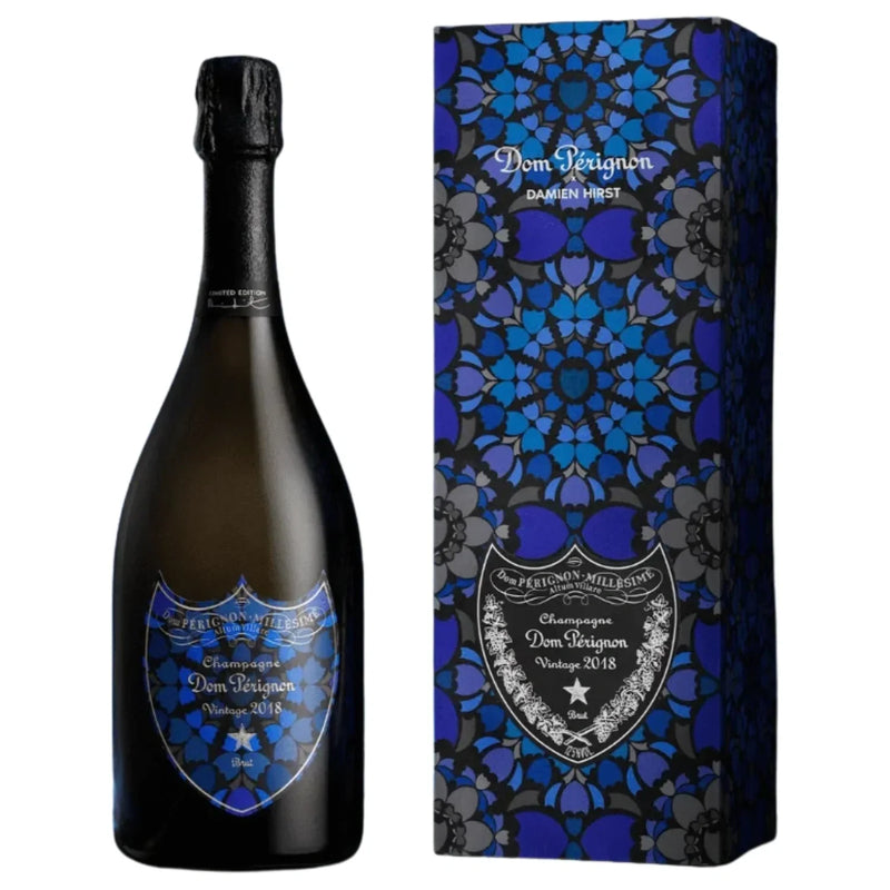 Load image into Gallery viewer, A bottle of Dom Pérignon Vintage 2018 Damien Hirst Limited Edition Brut Champagne and its gift box, both featuring a dark blue and black geometric floral pattern and matching labels.
