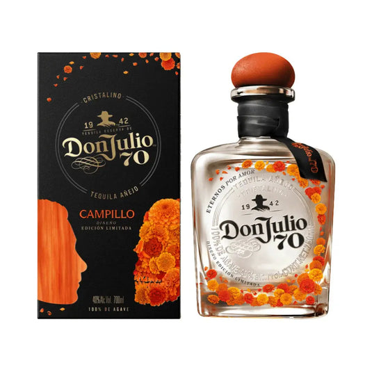 A bottle of Don Julio 70 Cristalino Añejo Tequila Day of the Dead 2026 Limited Edition by Don Julio Tequila stands beside its vibrant, marigold-adorned box—perfect for celebrating Día de los Muertos. Pre-order now!.