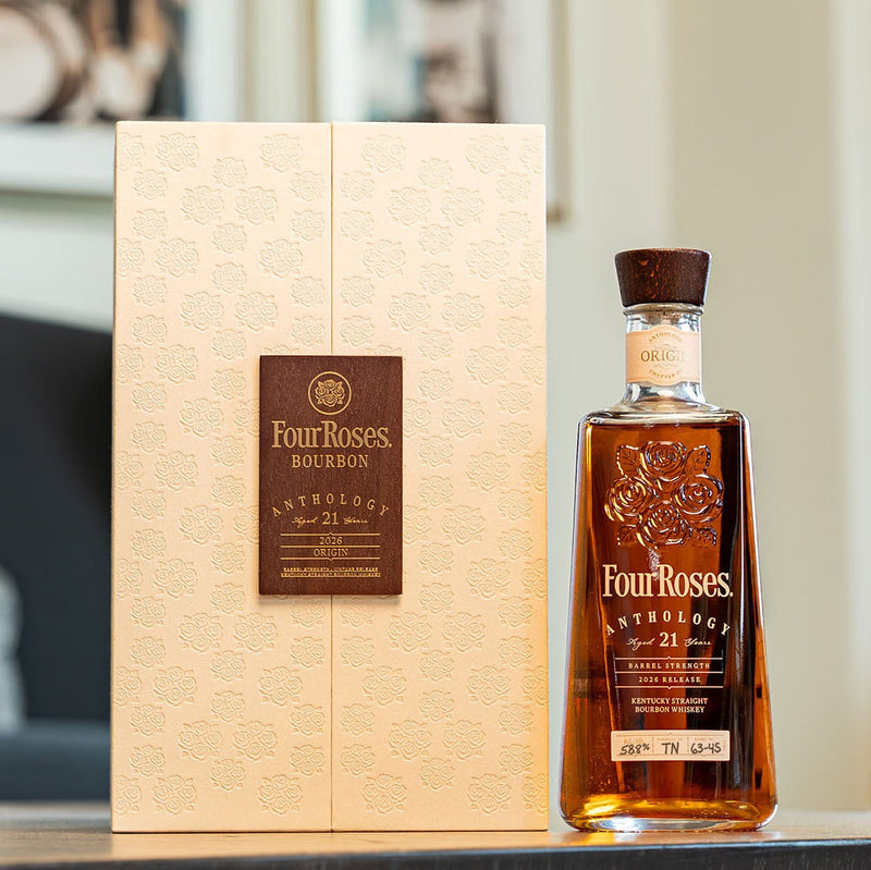 Load image into Gallery viewer, A bottle of Four Roses The Anthology Series Chapter 1: Origin 21 Year Bourbon from Main Street Liquor stands beside its embossed cream box with a brown label on a reflective surface, capturing elegance and rich Kentucky bourbon heritage.
