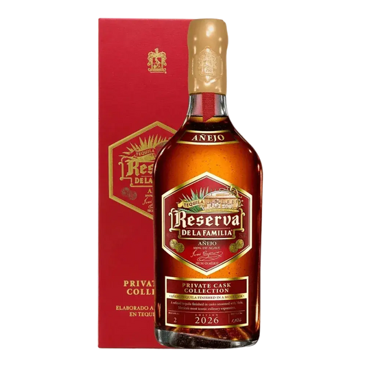 A bottle of Jose Cuervo Reserva de la Familia Private Cask Collection Añejo 2026 tequila in front of its matching red display box.