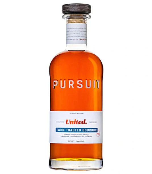 A clear glass bottle of Pursuit Spirits’ Pursuit United Twice Toasted Bourbon 700mL, featuring amber bourbon, a wooden cap, and a white label with the product name and details.