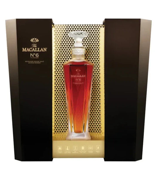A bottle of The Macallan No. 6 Lalique Single Malt Scotch Whiskey by The Macallan, presented in a luxury crystal decanter and displayed in an elegant black and gold box with geometric patterns.