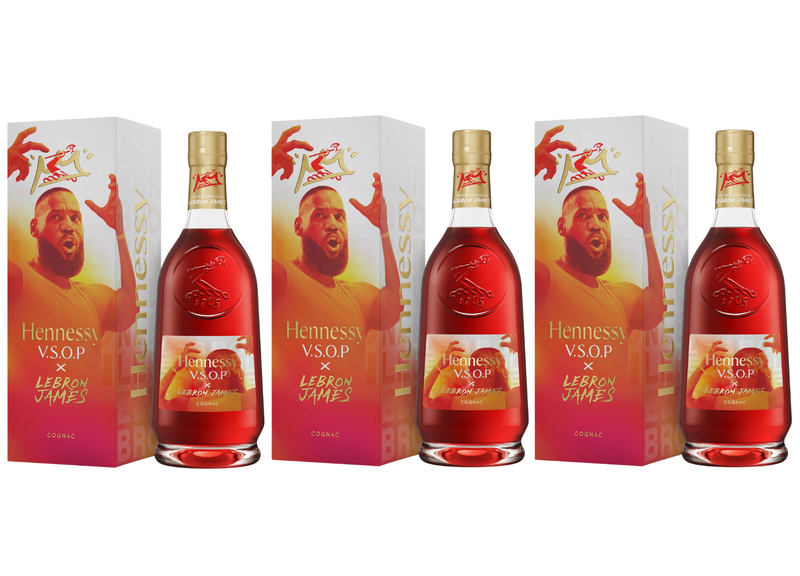 Load image into Gallery viewer, Three Hennessy V.S.O.P x LeBron James Limited Edition Cognac bottles stand before boxes featuring LeBron&#39;s raised arm and a bold red-and-yellow design, highlighting this unique Hennessy tribute to the basketball legend.
