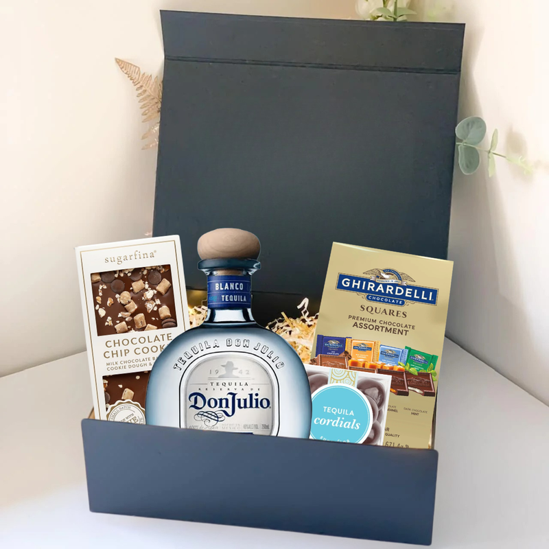 Load image into Gallery viewer, The Premium Tequila Gift Box by Main Street Liquor includes Don Julio premium tequila, Ghirardelli gourmet chocolate, Sugarfina chocolate chip cookie candies, and tequila cordials, all elegantly arranged with decorative filler.
