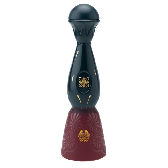 A dark, bell-shaped Clase Azul Día de Muertos Trascender 2026 Limited Edition Añejo Tequila 1L decanter with a round stopper, featuring gold floral accents on the neck and a base with deep red engraved floral patterns.