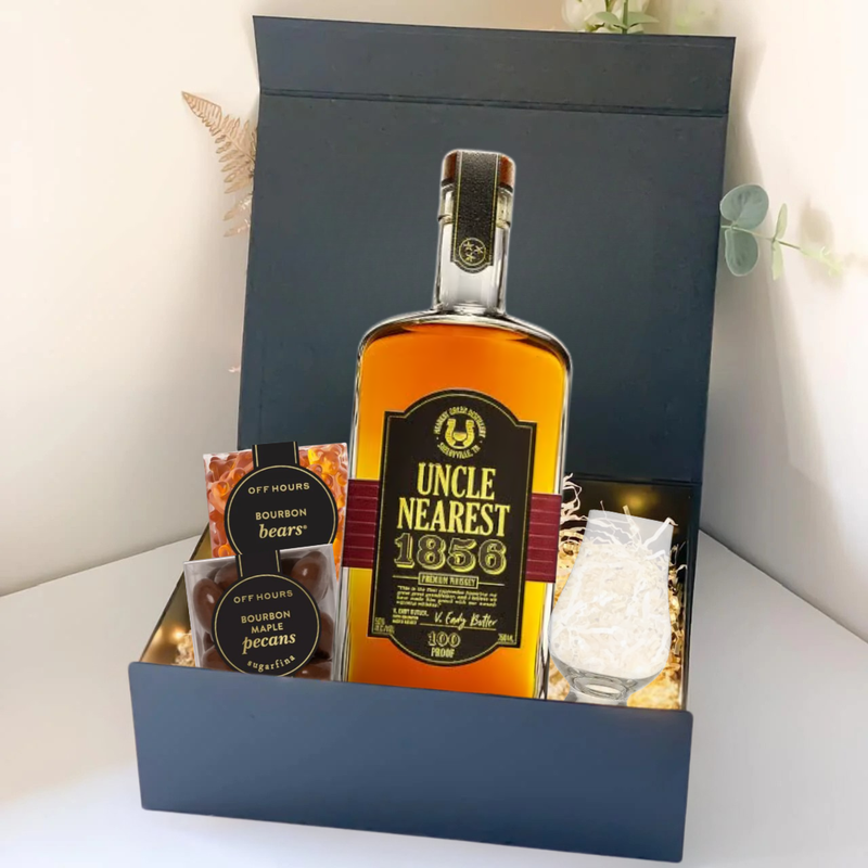 Load image into Gallery viewer, The Premium Bourbon Gift Box by Main Street Liquor features Uncle Nearest 1856 whiskey, Bourbon Bears, Bourbon Pecans, a clear glass, and decorative paper—a perfect whiskey gift set.
