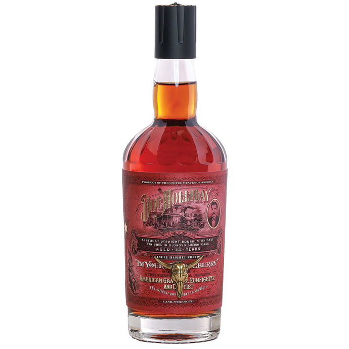 An unopened bottle of Doc Holliday 13-Year Bourbon Oloroso Sherry Finish features a red label with decorative text, vintage imagery, and Doc Holliday’s portrait. The Kentucky straight bourbon whiskey is sealed with a black cap.