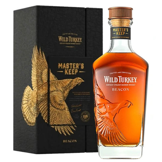 A bottle of Wild Turkey Master’s Keep Beacon Kentucky Straight Bourbon Whiskey is shown beside its matching black and gold box, both featuring the signature Wild Turkey branding and a special embossed flying turkey design.