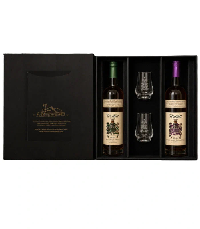 Load image into Gallery viewer, The Willett Distillery Family Estate 2-Bottle Gift Set (750mL) includes bourbon and rye, each with colored caps, plus two Willett glasses, all organized in separate compartments.
