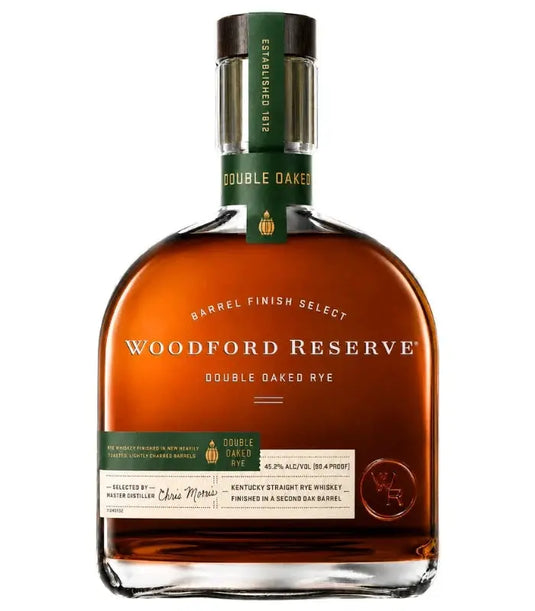 A bottle of Woodford Reserve Double Oaked Rye Whiskey (Pre-Order) by Woodford Reserve, featuring a green label with gold lettering, a distinctively shaped bottle, and a cap embossed with text.