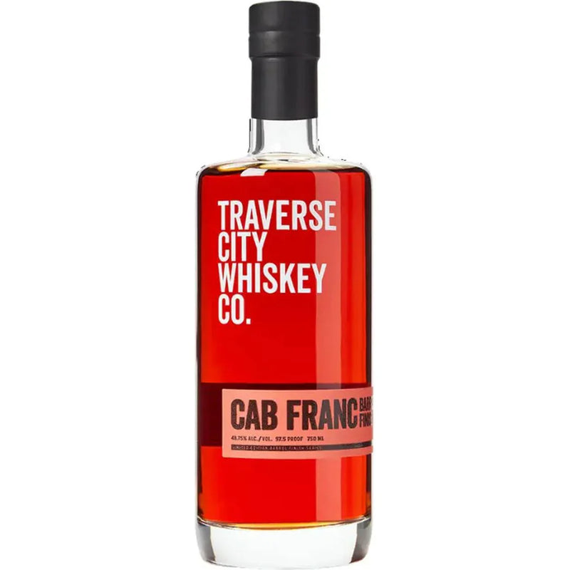 Load image into Gallery viewer, A bottle of Traverse City Whiskey Co. Cab Franc Barrel Finish features a black cap, bold red and white label on clear glass, and displays its rich amber whiskey.
