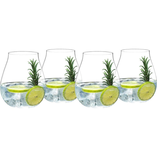 Four Riedel Gin glasses from the Riedel Gin Set of 4 are filled with ice, water, lime slices, and sprigs of rosemary, arranged in a row to evoke the elegance of this classic cocktail set.