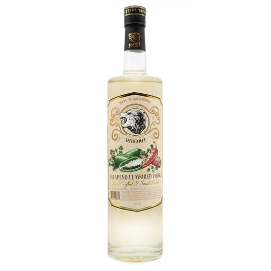 A bottle of Hideout Spicy Jalapeno Flavored Vodka from Hideout Vodka, featuring a clear bottle with a beige and gold label adorned with an eagle’s head and images of red and green jalapeños. The vodka inside appears slightly tinted.