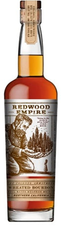 A bottle of Redwood Empire Colonel Armstrong Bourbon by Redwood Empire Whiskey showcases a detailed label with a bearded giant holding trees. The brown and silver design highlights the rich amber bourbon inside.