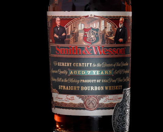 Close-up of a Smith & Wesson 7 Year Straight Bourbon Whiskey label, featuring portraits, a crest, and gold, red, and green text emphasizing its status as an American whiskey aged 7 years.